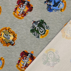 Reststück: 1,00m Baumwolljersey Lizenz -Star Wars Wappen der 4 Hogwarts Häuser - hellgrau